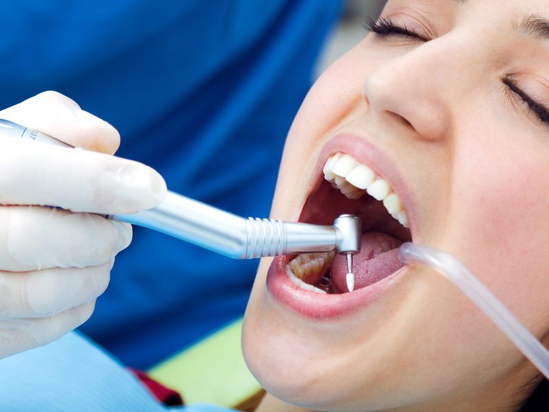 Medical scene of cute young woman at the dentist.