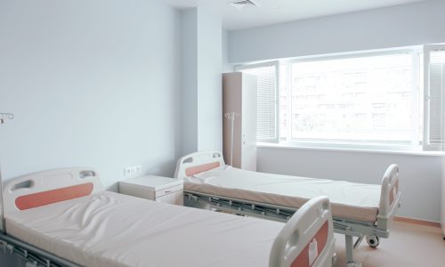Hospital beds against the wall and other medical equipment in a hospital room