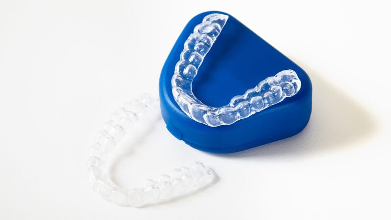 two dental whitening trays and a box for it